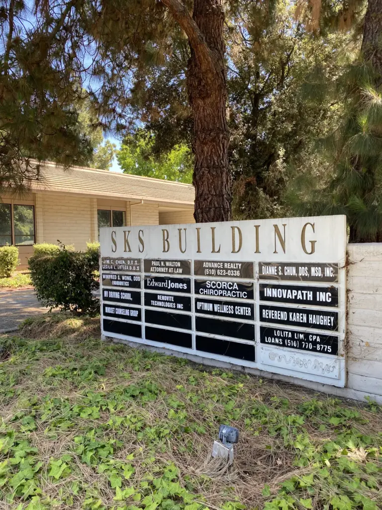 The SKS Building directory board listing Scorca Chiropractic among the offices