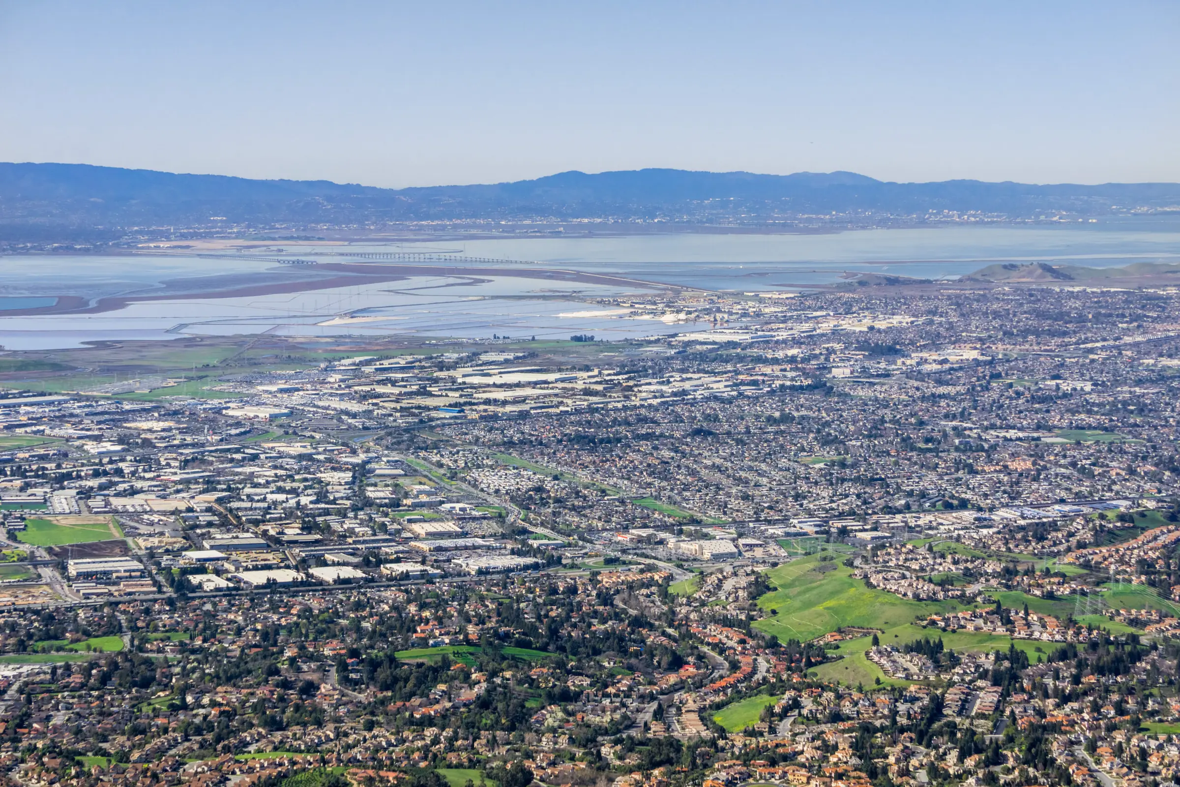 Fremont from the hills: the city, the salt ponds and the Dumbarton Bridge on San Francisco Bay, with the Santa Cruz Mountains beyond