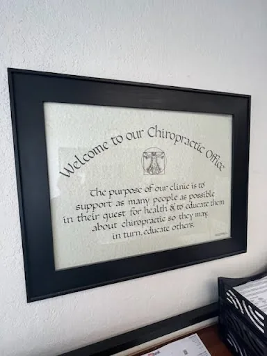 A framed calligraphy sign: "Welcome to our Chiropractic Office"